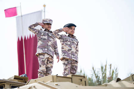 Doha, Qatar, December 18,2019. Qatari children dressed in traditional and military clothes for...