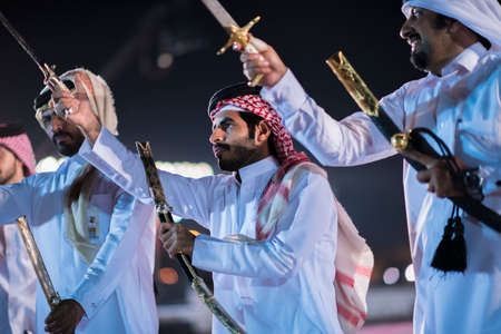 Doha,Qatar - December 18,2017. Traditional bedouin sword dancing for celebration Qatar national day.のeditorial素材