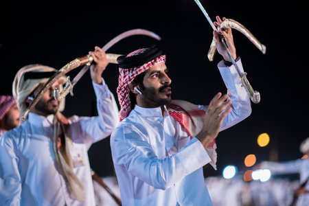 Doha,Qatar - December 18,2017. Traditional bedouin sword dancing for celebration Qatar national day.のeditorial素材