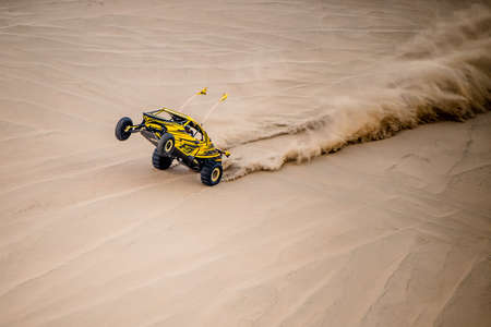 Doha, Qatar- February 23, 2018: Off road buggy car in the sand dunes of the Qatari desert.