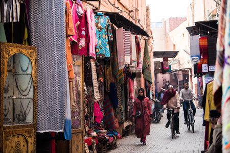 Marrakesh, Morocco - February 28, 2020: A typical street in the ancient Medina district of Marrakech. Photo contains local people doing various activities.のeditorial素材
