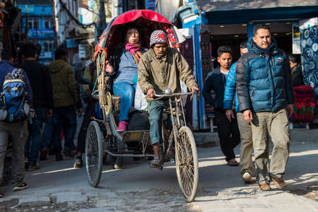 Kathmandu, Nepal - April 20,2019 : Cycle rickshaw on the streets of Kathmandu. In terai region of Nepal, cycle rickshaws are still the most popular means of public transport for short-distance.のeditorial素材