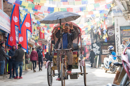 Kathmandu, Nepal - April 20,2019 : Cycle rickshaw on the streets of Kathmandu. In terai region of Nepal, cycle rickshaws are still the most popular means of public transport for short-distance.のeditorial素材