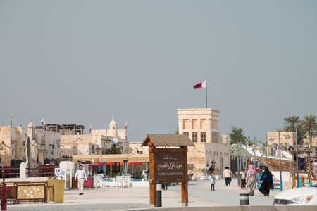 Doha ,Qatar - February 01,2020 : New souk Al Wakrah waterfront promenade with his traditional housesÂ and local people enjoying walking.のeditorial素材