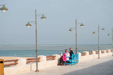 Doha ,Qatar - February 01,2020 : New souk Al Wakrah waterfront promenade with his traditional housesÂ and local people enjoying walking.のeditorial素材