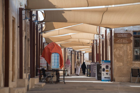 Doha ,Qatar - February 01,2020 : New souk Al Wakrah waterfront promenade with his traditional housesÂ and local people enjoying walking.のeditorial素材