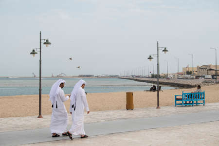 Doha ,Qatar - February 01,2020 : New souk Al Wakrah waterfront promenade with his traditional housesÂ and local people enjoying walking.のeditorial素材