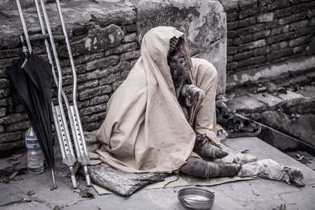 Kathmandu, Nepal- April 20,2019 : The cripple begs on the street of Pashupatinath Temple in Kathmandu, Nepal.のeditorial素材