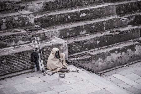 Kathmandu, Nepal- April 20,2019 : The cripple begs on the street of Pashupatinath Temple in Kathmandu, Nepal.のeditorial素材