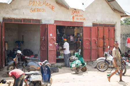 Zanzibar City, Tanzania - May 01,2022: Street view of the usual daily life of local people all ages taking place along the road on the Zanzibar Island in Tanzania.のeditorial素材