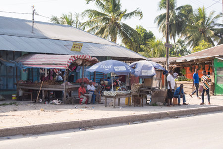 Zanzibar City, Tanzania - May 01,2022: Street view of the usual daily life of local people all ages taking place along the road on the Zanzibar Island in Tanzania.のeditorial素材