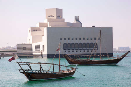 Doha,Qatar- April 24,2022 :  Traditional dhow boats with the futuristic skyline of Doha in the...