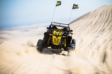 Doha, Qatar- April 23, 2022: Off road buggy car in the sand dunes of the Qatari desert.