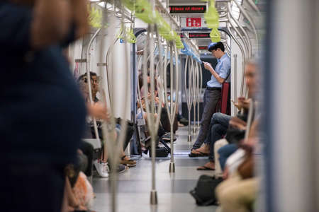 Singapore City, Singapore - September 08, 2019:  Passengers in a Mass Rapid Transit (MRT) subway train in Singapore.のeditorial素材