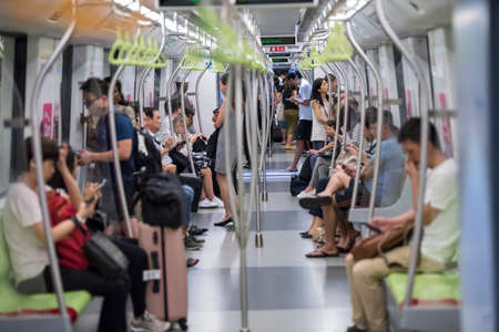 Singapore City, Singapore - September 08, 2019:  Passengers in a Mass Rapid Transit (MRT) subway train in Singapore.のeditorial素材