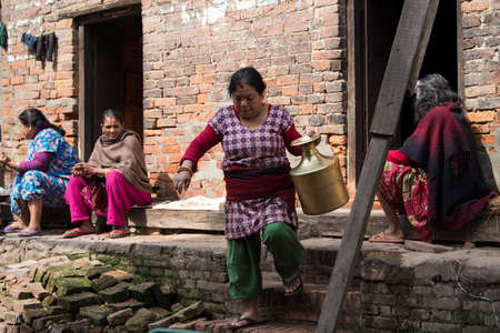 Portrait of a Nepali woman selling milk at the Pashupatinath temple in the morningの写真素材