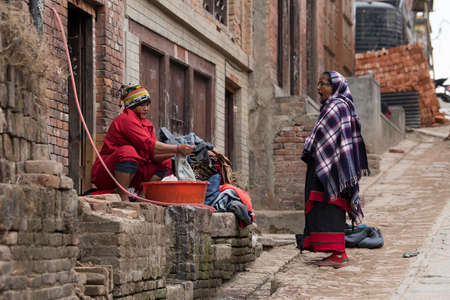 View of unknowns people cleaning the streets of Kathmandu in the morning