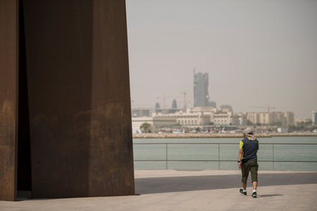 Doha,Qatar - March 05, 2019 : People enjoying a sunny day in the park of the Museum of Islamic Art in Doha.のeditorial素材
