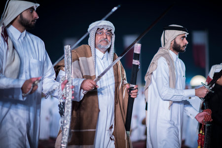 Doha,Qatar,December-18,2017: The sword dance called the "ardha" at the Darb Al Saai grounds, organized to celebrate Qatar National Day.のeditorial素材