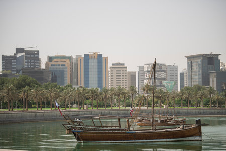 Doha,Qatar- April 24,2022 Traditional boats called Dhows are anchored in the port near the Museum of Islamic Art Park.のeditorial素材