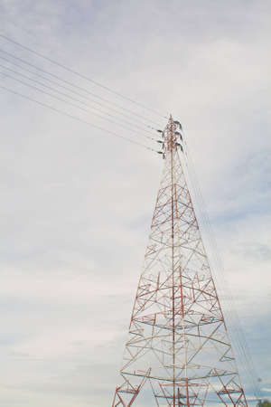 High-voltage poles and blue skyの写真素材