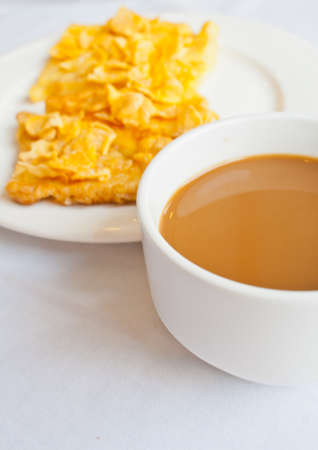 Coffee and bread topped with honey