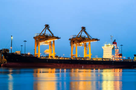 Container and crane in shipyard at dusk for cargo Goods and Logistic in harborの写真素材