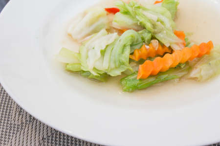 Stir fry cabbage with garlic sliced carrots on a white dishの写真素材
