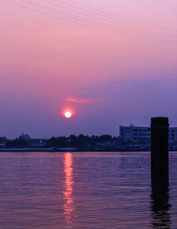 Sunset over city view on riverの写真素材