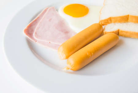 Breakfast style sausage and ham with  eggの写真素材
