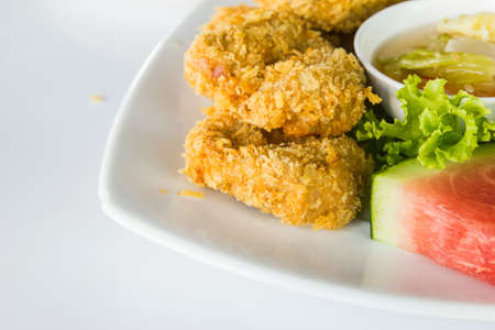 Fried shrimp cake served on white dish