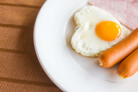 Breakfast style sausage and egg with hamの写真素材