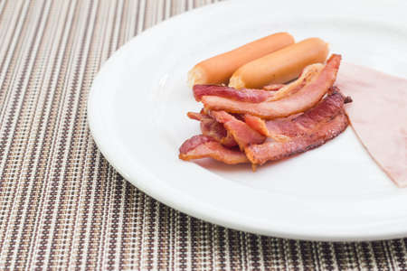 Breakfast style sausage and bacon with hamの写真素材