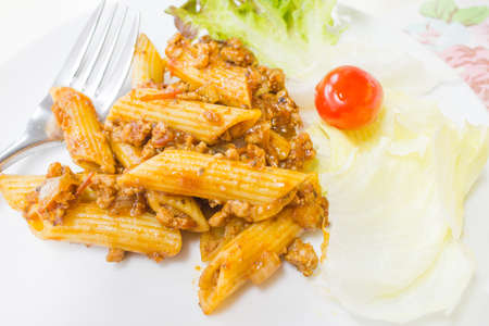 Macaroni Sauce with minced pork on white dishの写真素材