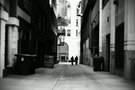 Two men walking down an alley