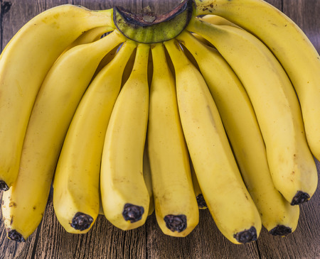 Close up to bananas on a wooden surfaceの写真素材