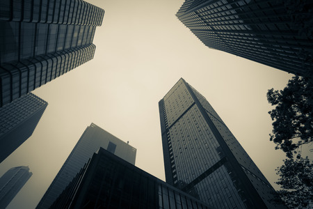 Low angle view of urban buildings in the cityの写真素材