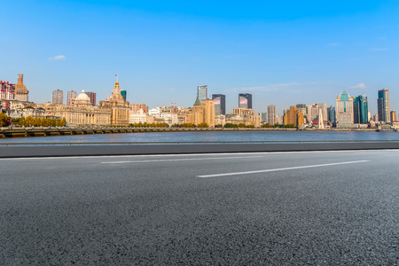 Highway asphalt road and commercial office buildingの写真素材