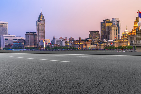 Highway asphalt road and commercial office buildingsの写真素材