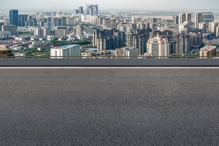 Empty asphalt road with commercial buildings in Chinaの写真素材