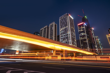 City buildings at night and blurred lightsの写真素材