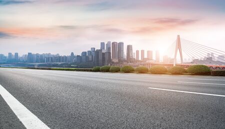 Asphalt road skyline and Chongqing buildings backgroundの写真素材