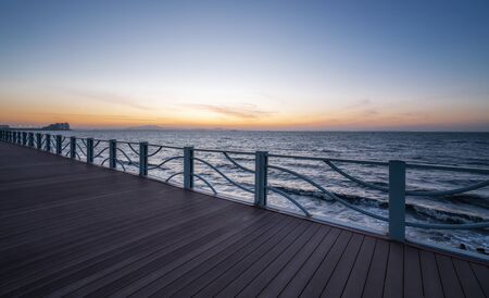 Wooden path and sunset seascape