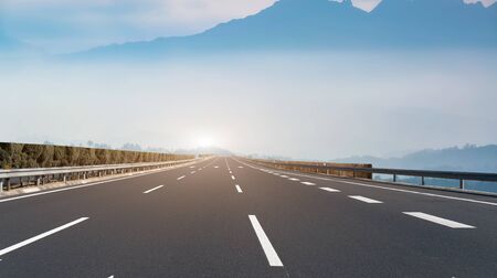 Road and distant mountain landscapeの写真素材