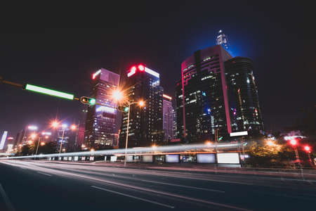 the light trails on the modern building backgroundの写真素材