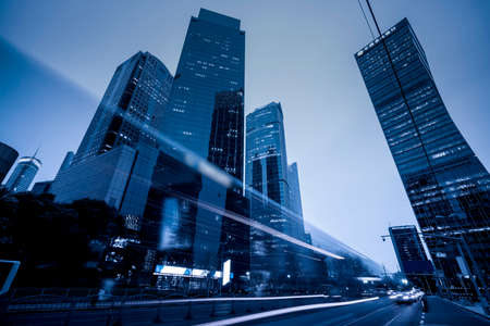 the light trails on the modern building backgroundの写真素材