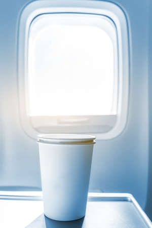 Aircraft cabin glass and paper cupsの写真素材