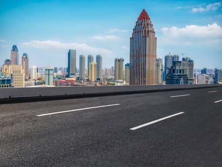 Highway lanes and financial district buildingsの写真素材