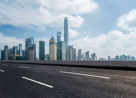 Highway lanes and financial district buildingsの写真素材