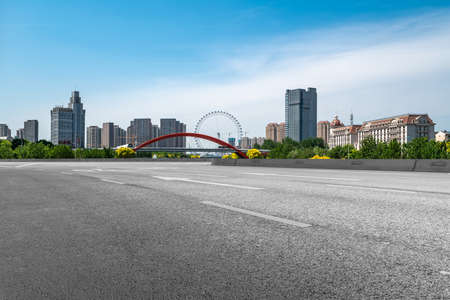 Asphalt road and city buildings landscapeの写真素材